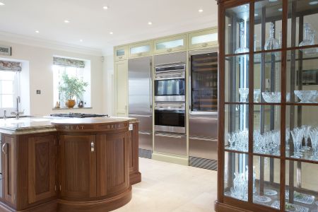 A bespoke shaker kitchen with a centre island with a wine rack, and bespoke glass shelf.