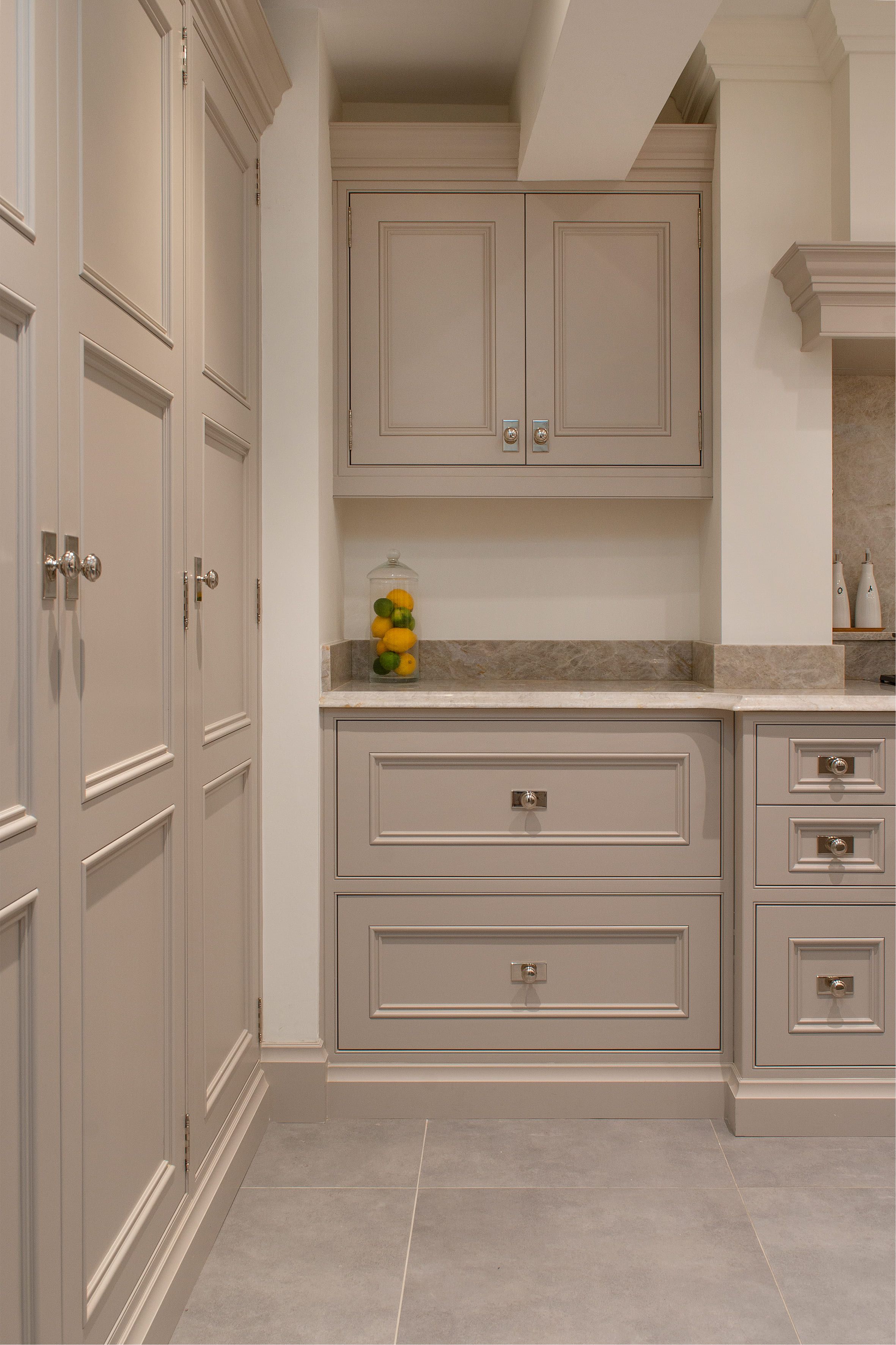 A number of bespoke shaker-style cabinets in a light-grey colour.